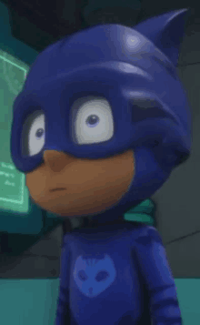 a close up of a cartoon character in a pj masks costume looking at the camera .