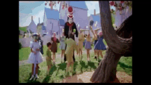 a group of children are dancing with cat in the hat in the background