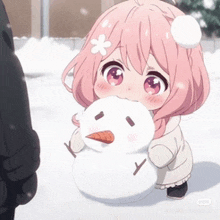 a little girl with pink hair is holding a snowman in her hand