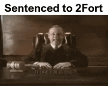 a black and white photo of a judge sitting at a desk with a gavel and the words sentenced to 2 fort above him