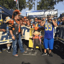 a group of people are standing in front of a sign that says thunder alley