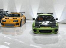 a yellow sports car and a green sports car are parked next to each other in a garage