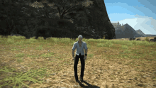 a man in a white shirt and black pants stands in a grassy field