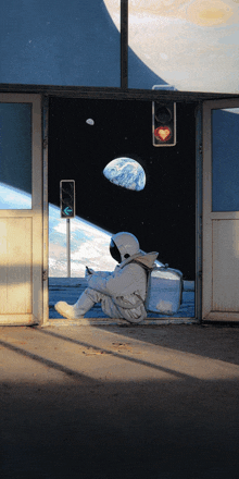 a man in a space suit sits on the ground in front of an open door