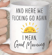 a mug that says " and here we fucking go again "