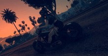 a woman is riding a motorcycle down a road at sunset