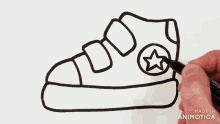 a person is drawing a shoe with a star on the side of it