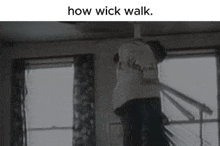 a black and white photo of a man hanging from the ceiling with the caption how wick walk