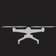 a silhouette of a drone on a black background with two wings .