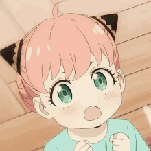 a little girl with pink hair and green eyes has a cat ear on her head