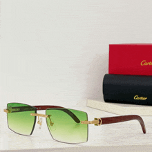 a pair of green cartier sunglasses sits on a shelf