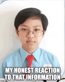 a young boy wearing glasses and a blue shirt and red tie .