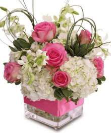 a pink vase filled with pink roses and white hydrangeas