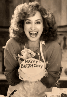 a woman holding a cake that says happy birthday on it