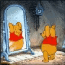 winnie the pooh is standing in front of a mirror and looking at himself .