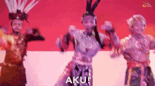 a group of people are dancing and the word aku is on the bottom