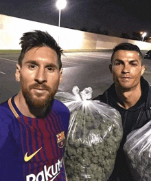 two men standing next to each other one of whom is wearing a barcelona shirt