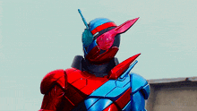 a close up of a red and blue robot with a antenna on its head .