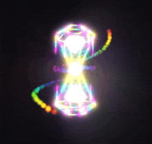 a rainbow colored hourglass with a diamond in the middle