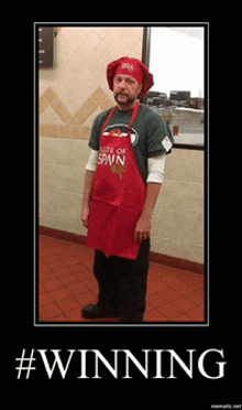 a man wearing an apron that says taste of spain stands in a kitchen