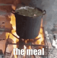 a pot of food is cooking on a stove with the words the meal written on the bottom