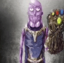 a purple alien is holding a infinity gauntlet in his hands .