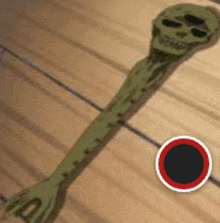 a green fork with a skull on it is on a wooden table