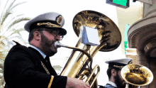 a man in a military uniform plays a brass instrument