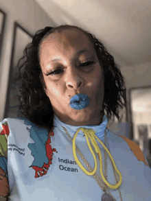 a woman wearing a shirt that says indian ocean blows a kiss