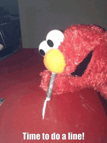 elmo is holding a yellow ball in his mouth and says time to do a line on the bottom