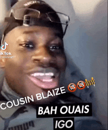 a man wearing glasses and a hat is smiling with the words cousin blaize bah ouais igo on the bottom