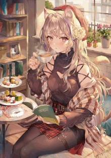 a girl with cat ears is sitting at a table drinking a cup of coffee and reading a book