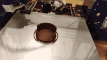 a 3d printer is printing a piece of brown material