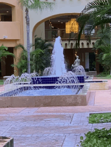 a fountain in front of a building with a sign that says ' a ' on it