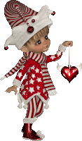 a little girl in a red and white outfit is holding a heart shaped ornament