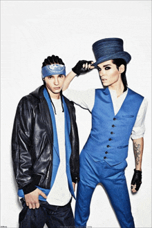 two men standing next to each other one wearing a top hat and the other wearing a bandana that says " i love you "