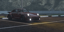 a red porsche is parked in a parking lot with a mountain in the background