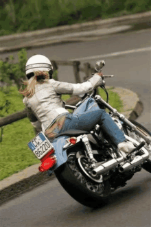 a woman on a motorcycle with a license plate that says cc 86220