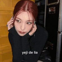 a woman with red hair has the word yeji de lia written on her face