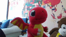 a stuffed animal in front of a map of the world with flags on it