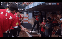 a group of baseball players in a dugout with kbsn sports live