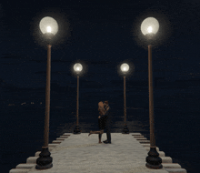 a man and woman are kissing on a dock at night