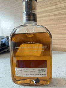 a bottle of woodford reserve kentucky straight bourbon whiskey is sitting on a counter