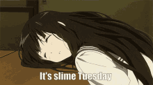 a girl laying on a table with the words it 's slime tuesday written below her