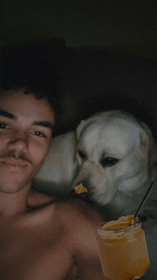 a man with a jar of peanut butter and a dog behind him