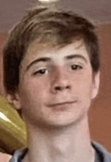 a close up of a young man 's face with a serious look on his face .