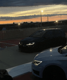 a row of cars are parked in a parking lot with the numbers 21 and 20 visible