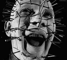 a close up of a person 's face with nails sticking out of it .