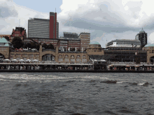 a view of a city from across the water with a large building in the background that says ' frankfurt ' on it