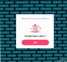 a screenshot of a video showing a double layer cake with an ok button